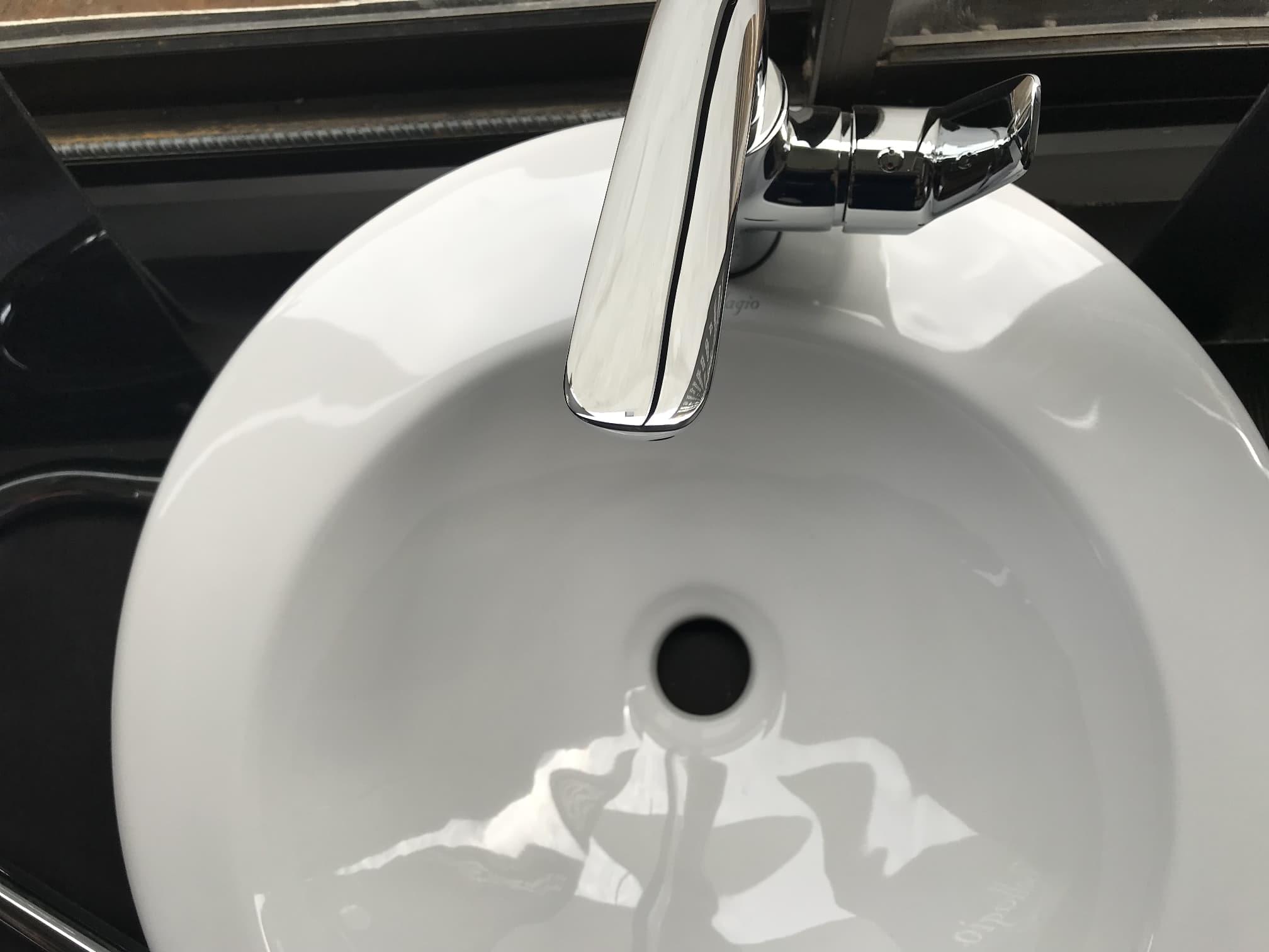 Pearl colored sink professionally cleaned.